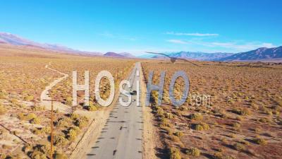 Aerial Video Of A 4wd Wheel Drive Vehicle On A Paved Road Across The Owens Valley Desert Region Suggests Remote Eastern Sierra Adventure - Video Drone Footage