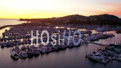 2020 - Dusk Or Twilight Aerial Video Over Santa Barbara Harbor With Many Boats At Dock - Video Drone Footage