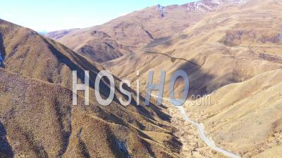 2019 - Cars Traveling On A Road Through Dry Mountain Landscape In The South Island Of New Zealand - Aerial Video By Drone