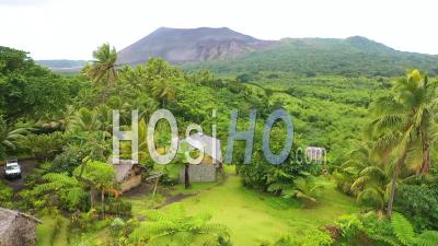 2019 – Jungle Village On The Island Of Tanna Reveals Mt. Yasur Volcano In The Distance, Vanuatu - Aerial Video By Drone