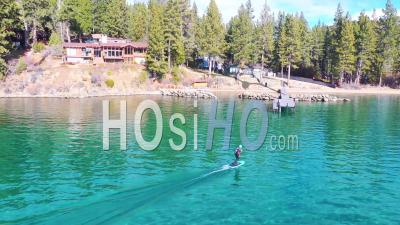 2020 - A Man Rides A Hydrofoil Efoil Electronic Surfboard Across Lake Tahoe, California In An Extreme Hydrofoiling Foil Sport Demonstration. - Video Drone Footage
