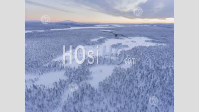 Aerial Drone Photo Of Remote Snow Covered Lake And Winter Landscape In The Dramatic Wilderness Of Lapland, Scandinavia, Finland