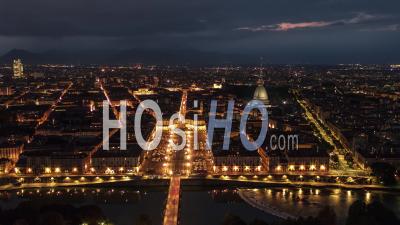 Establishing Aerial View Shot Of Turin It, Mole Antonelliana On The Horizon, Torino Skyline, Italy At Night Evening - Video Drone Footage