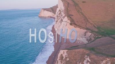 White Chalk Cliffs At Durdle Door At Sunrise, Lulworth Cove, Dorset, England, Uk. Aerial Drone View