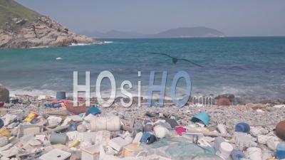 Environmental Impact Of Beach Covered In Plastic And Rubbish In Hong Kong. Aerial Drone View