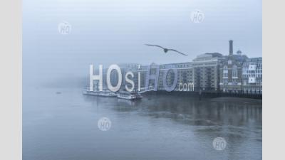 Butlers Wharf Pier And River Thames In Thick Fog And Mist, On A Cool Winter Morning In The City In Foggy And Misty Moody Weather During Covid-19 Coronavirus Lockdown, England, Uk