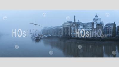 Butlers Wharf Pier And River Thames In Thick Fog And Mist, On A Cool Blue Morning In Foggy And Misty Moody Weather In London City Centre During Covid-19 Coronavirus Lockdown, England, Uk