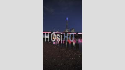 Vertical Video Of London Skyline With Lights At Night On The River Thames Beach At Low Tide Looking At The Shard, Shot In Coronavirus Covid-19 Lockdown