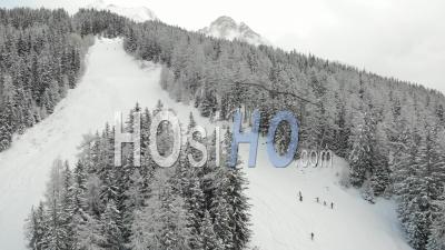Group Of Skiers Hiking A Close Ski Slope During Covid 19 Pandemic - Video Drone Footage