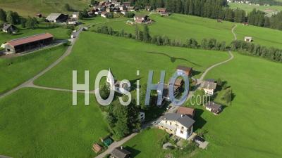 Medels Im Rheinwald, Swiss Alps Cliffs, Green Meadows And A Village - Video Drone Footage