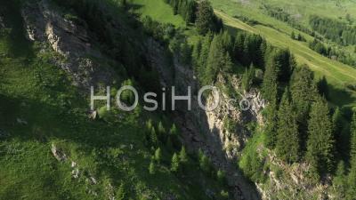 Rocks And Green Meadows In The Swiss Alps Aerial View - Video Drone Footage