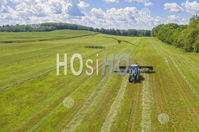 Farmer Pulls Hay Rake In Michigan Field - Aerial Photography