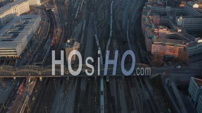 Cars On Bridge Over Going Multiple Train Track Railway Of Munich, Germany Central Train Station, Aerial Birds Eye Overhead Top Down View - Video Drone Footage