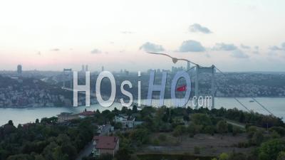 Turkish Flag Waving In Wind In Front Of Istanbul Bosphorus Bridge And City Skyline At Beautiful Sunset, Establishing Aerial Slide Right - Video Drone Footage