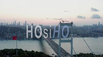 Istanbul 15 July Martyrs Bosphorus Bridge And City Skyline In Background With Turkish Flag At Beautiful Sunset, Aerial Slide Right - Video Drone Footage