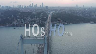 Big Bridge Leading Into The City Skyline, Car Traffic At Sunset In Istanbul, Aerial Dolly Slide Left - Video Drone Footage