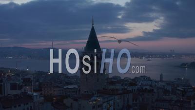Galata Tower Silhouette At Blue Hour With Bosphorus In Background And Red Purple Sky, Aerial Slide Left - Video Drone Footage