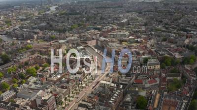 Wide Establishing Aerial View Of Amsterdam City Center Towards River With Boats 4k - Video Drone Footage
