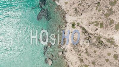 Overhead Top Down Aerial Flight Over Greek Island Milos Turquoise Blue Ocean With Rocky Cliff Coast 4k - Video Drone Footage