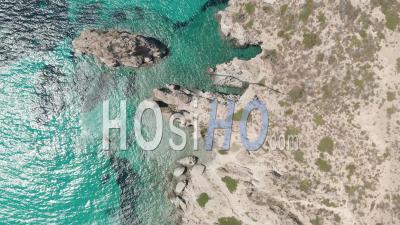 Overhead Top Down Aerial Flight Over Greek Island Milos Turquoise Blue Ocean With Rocky Cliff Coast 4k - Video Drone Footage