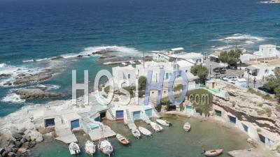 Typical Greek Fishing Village With White Houses And Waves Crashing 4k - Video Drone Footage