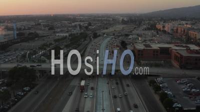 Over Busy Highway At Sunset With Palm Trees In Burbank, Los Angeles, California, Sunset 4k - Video Drone Footage
