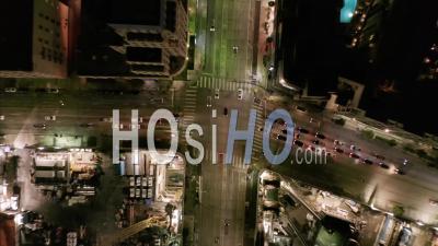 Aerial Hyper Lapse: Road Intersection At Night With Car Traffic And City Lights Time Lapse In Los Angeles, California 4k - Video Drone Footage