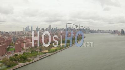Wide Aerial Dolly View Of Alphabet City And East Village Along The East River Waterfront With New York City Skyscrapers In The Background 4k - Video Drone Footage