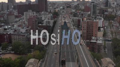 Aerial Dolly View Of Multi Lane Car Traffic Across Manhattan Bridge Towards Residential Buildings In Chinatown And Stopped Police Car With Flashing Lights On The Bridge 4k - Video Drone Footage