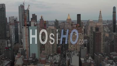 Rising Aerial Dolly Shot Climbing Above Tall Skyscrapers In Dense Urban City Center Of Manhattan, New York City 4k - Video Drone Footage