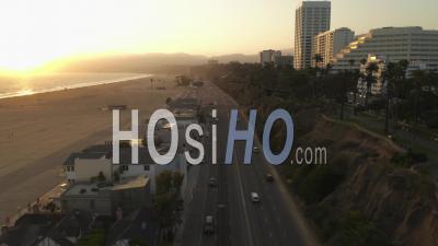 View Of Pacific Coast Highway Pch Next To Santa Monica Pier, Los Angeles With Light Traffic And Ocean View By At Sunset Waves, Summer 4k - Video Drone Footage