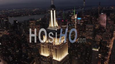 Flying Above Lit Up Parallel Avenues And Junctions, Residential Condominiums And Office Buildings In Midtown Manhattan, New York City At Night. Road Infrastructure In Metropolis 4k - Video Drone Footage