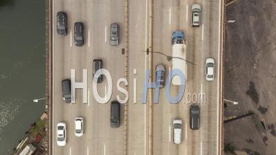 Top Down Overhead Aerial View Of Cars Crossing Lanes And Driving Down A Busy Road Overpass In Downtown City Area 4k - Video Drone Footage