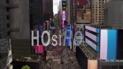 Aerial Static View Of Commercial Advertisements On A Tall Skyscrapers With The Crowds Of People On The Times Square In The Background 4k - Video Drone Footage