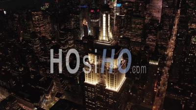 Breathtaking Circle View The Iconic Empire State Building Disappearing Behind Residential Condominiums And Office Buildings In Midtown Manhattan, New York City At Night 4k - Video Drone Footage