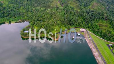Green Beautiful Scenery Of Calm Lake Near The Dam - Video Drone Footage