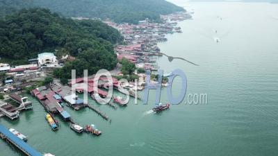 Aerial A Fishing Boat Leaving Jetty Pangkor Island - Video Drone Footage