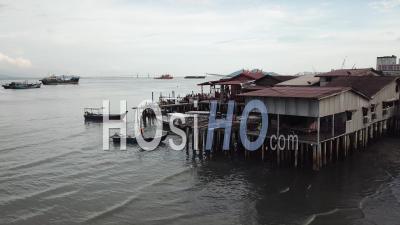 Aerial Fisherman Row The Boat Near Chew Jetty - Video Drone Footage