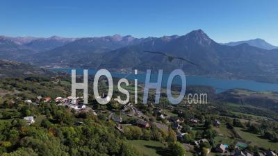The Lake Of Serre-Ponçon In The Durance Valley, From The Village Of Saint-Apollinaire, Hautes-Alpes, France, Viewed From Drone