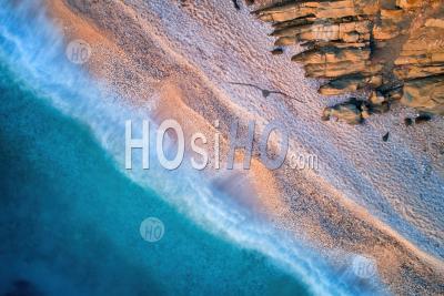 Vertical View Of Abandoned Gravel Mediterranean Beach. Deep Azure Sea, Warm Colored Stones And Rocks, - Aerial Photography