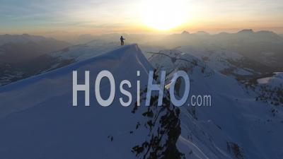 Skier On Top Of A Mountain - Video Drone Footage