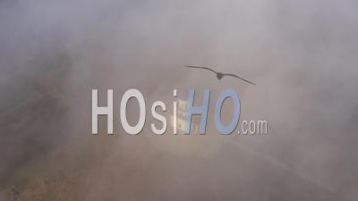 Top View Of The Chapel On A High Mountain In The Fog - Video Drone Footage