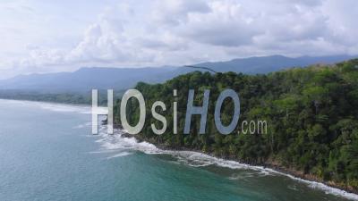 Aerial Drone View Of Rainforest On The Pacific Ocean Coast In Costa Rica, Coastal Tropical Jungle Landscape Scenery With The Sea And Beautiful Coastline, A Dramatic Seascape In Central America