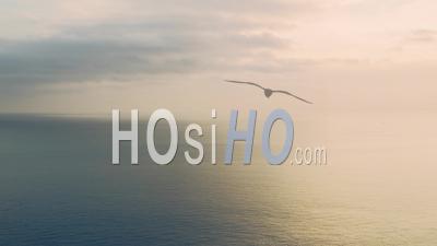 Aerial Drone View Of Calming Peaceful Orange Ocean Seascape Background Of Vast Sea And Sunset Clouds Over Horizon With Copy Space, Calm Still Water