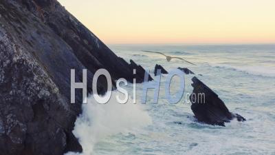 Aerial Drone View Of Portugal Atlantic Coast At Lisbon, A Dramatic Rugged Rocky Coastline With Waves Crashing And Breaking Against Rocks At Sunrise, Sintra, Europe