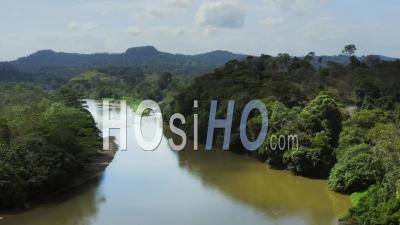 Aerial Drone View Of Rainforest River And Mountains Scenery In Costa Rica At Boca Tapada, San Carlos River (rio San Carlos) That Connects To Nicaragua In Central America, High Shot Above Trees