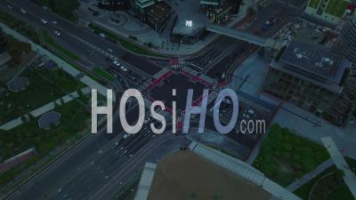 High Angle View Of Busy Road Intersection In Surrounding Modern High Rise Downtown Buildings. Vehicles Passing Through Crossroads. Milano, Italy. - Video Drone Footage