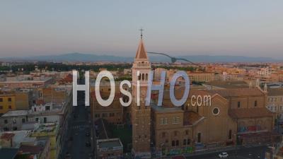Aerial Ascending Footage Of Church With Square Tower. Revealing Urban Boroughs With Residential Buildings At Twilight. Rome, Italy - Video Drone Footage