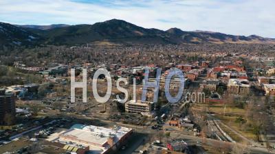 2022 - Aerial Of The Downtown Of Boulder, Colorado And Suburbs With Front Range Of The Rocky Mountains In Background, Winter - Video Drone Footage