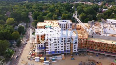 2022 - Good Aerial Over A Large Construction Site With Crane And Workers - Video Drone Footage